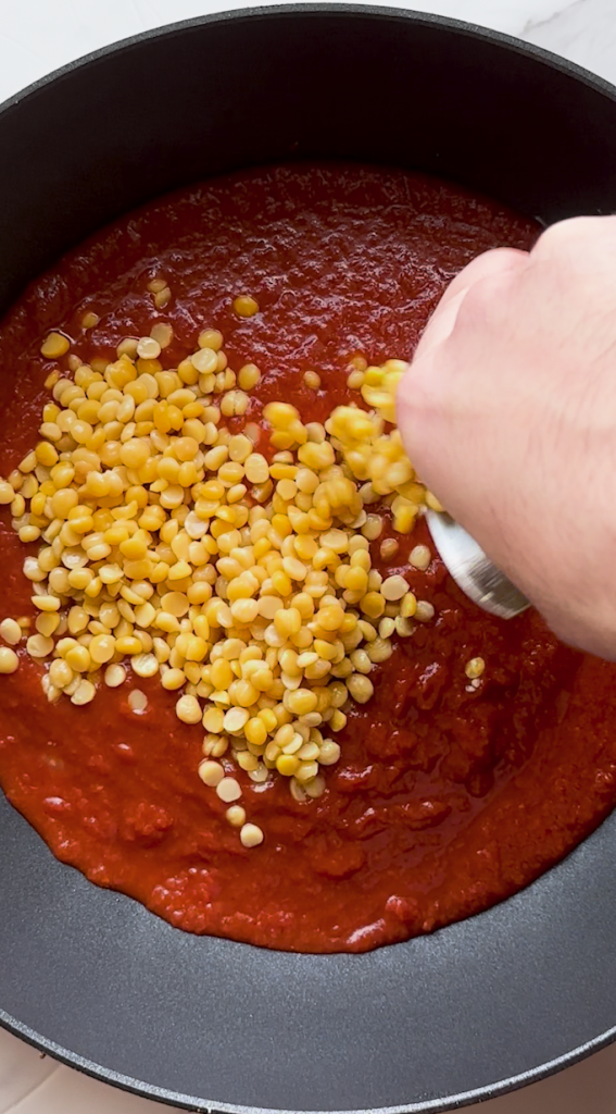 sauce prepped for Mantu topping with split yellow peas and seasonings